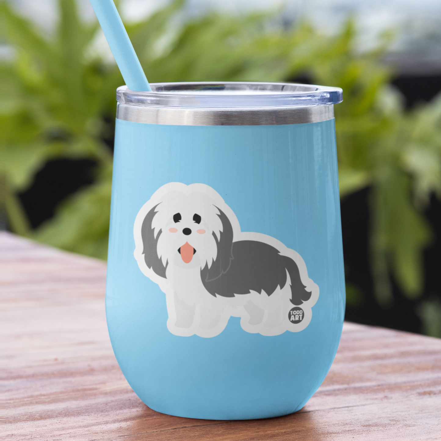Light blue tumbler featuring Boo-Boo Buddies® collectible vinyl sticker of a fluffy cartoon Sheepdog – fun dog sticker for decorating water bottles, laptops, notebooks, and gifts for kids
