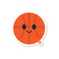 A die-cut vinyl sticker of a smiling basketball character designed with a white outline and a high-quality glossy finish.