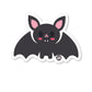 A die-cut vinyl sticker of a cute cartoon bat with a glossy finish.