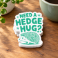 Pile of matching Need a Hedge Hug mint-green hedgehog stickers with the top design visible.