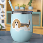 Cute Basset Hound Boo-Boo Buddies® collectible vinyl sticker on a pastel blue tumbler with straw, sitting on a table in a cozy indoor setting
