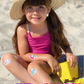 Kid wearing Boo Boo Buddies Bandages at the beach